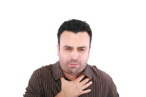 young ill man coughing isolated over white background